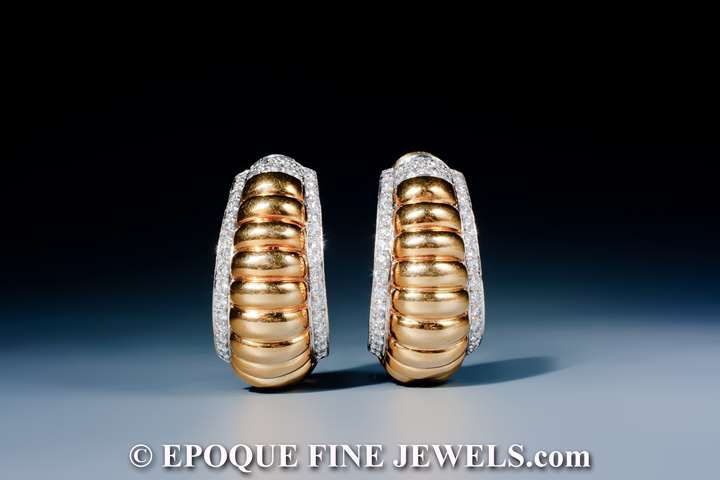 A fine pair of 18 karat gold and diamond earrings,